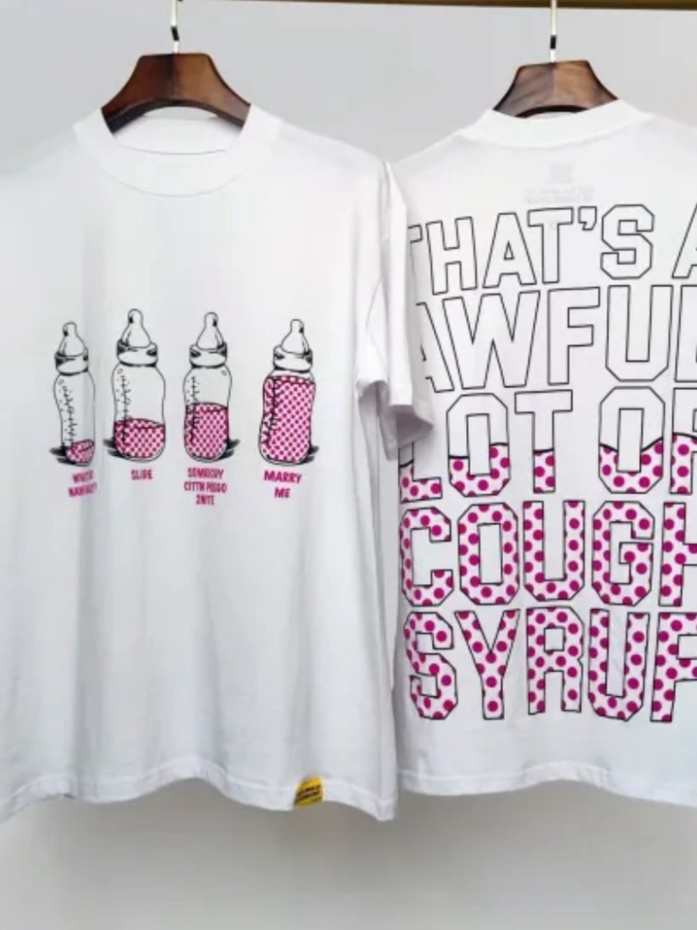 White Short-Sleeve Graphic Tee with Pink Bottle and Text Design